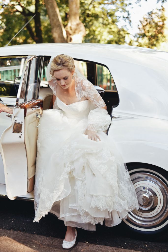 English bride getting out of the Rolls Royce wedding car at St George's Anglican Church