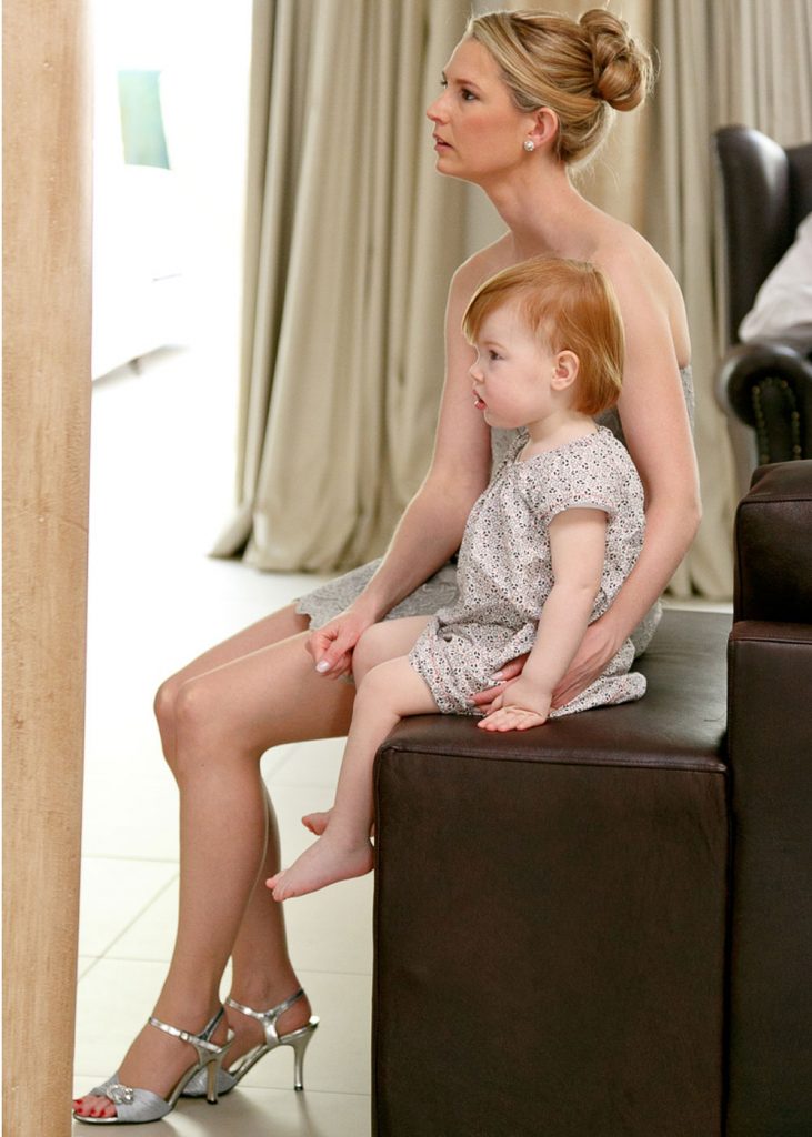 you girl sitting with mother