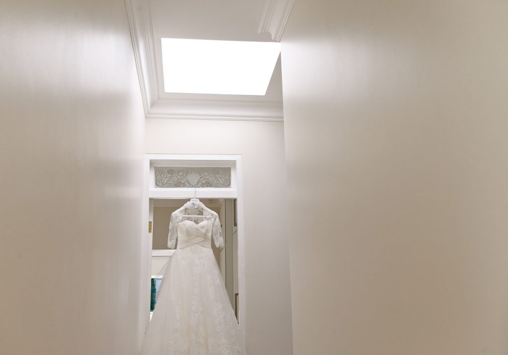 bridal dress hanging in passage