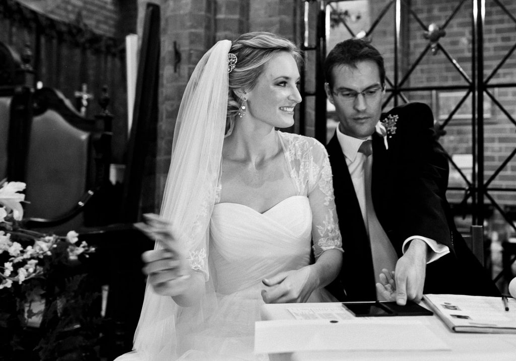 the black and white wedding image of a couple signing the register St George's Anglican Church Parktown