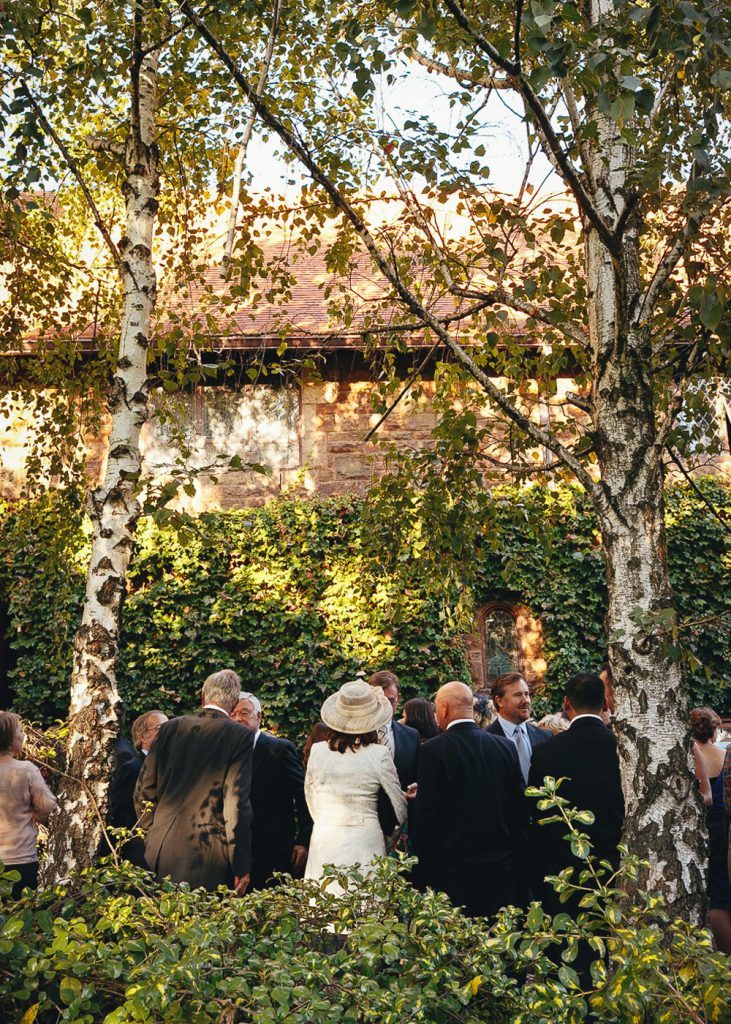 wedding guests standing under the green trees at Saint George's Anglican Church Parktown Johannesburg