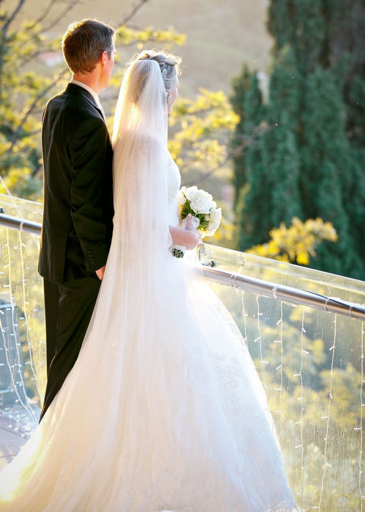 bride and groom on the balcony at Emoyeni