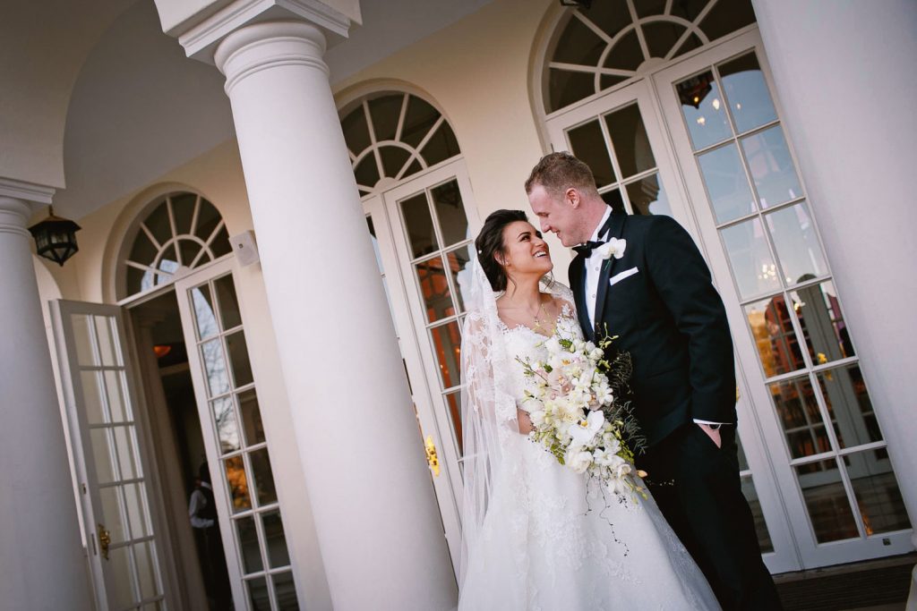 a wedding couple standing at the doors at the Westcliff Hotel