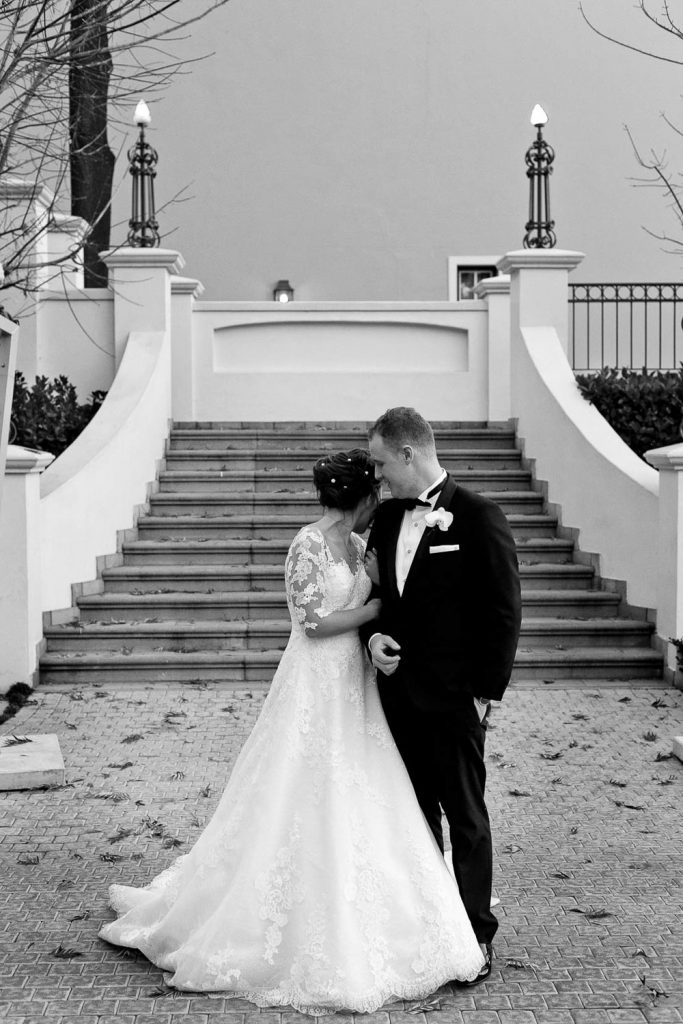 wedding couple standing at stairs at the Fourseasons Hotel The Westcliff Hotel Johannesburg