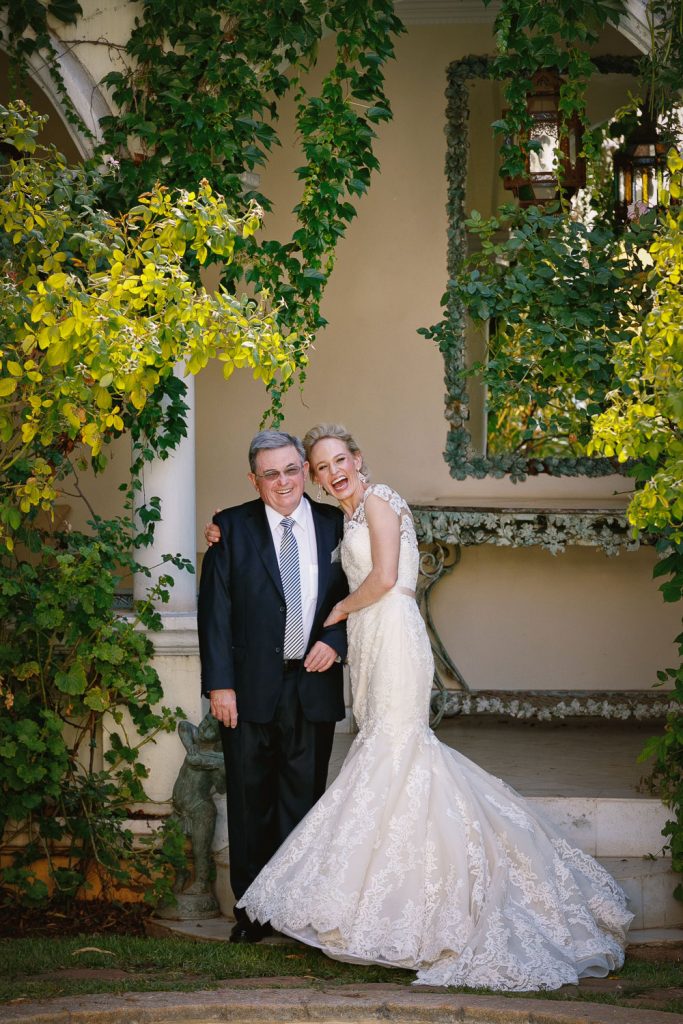 Bride laughing with her father at Illyria House in Pretoria
