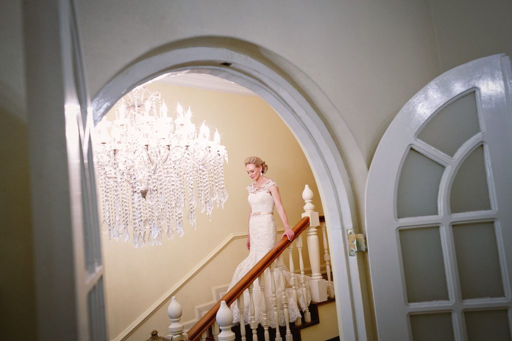 Bride walking down the stairs at  Illyria House in Pretoria