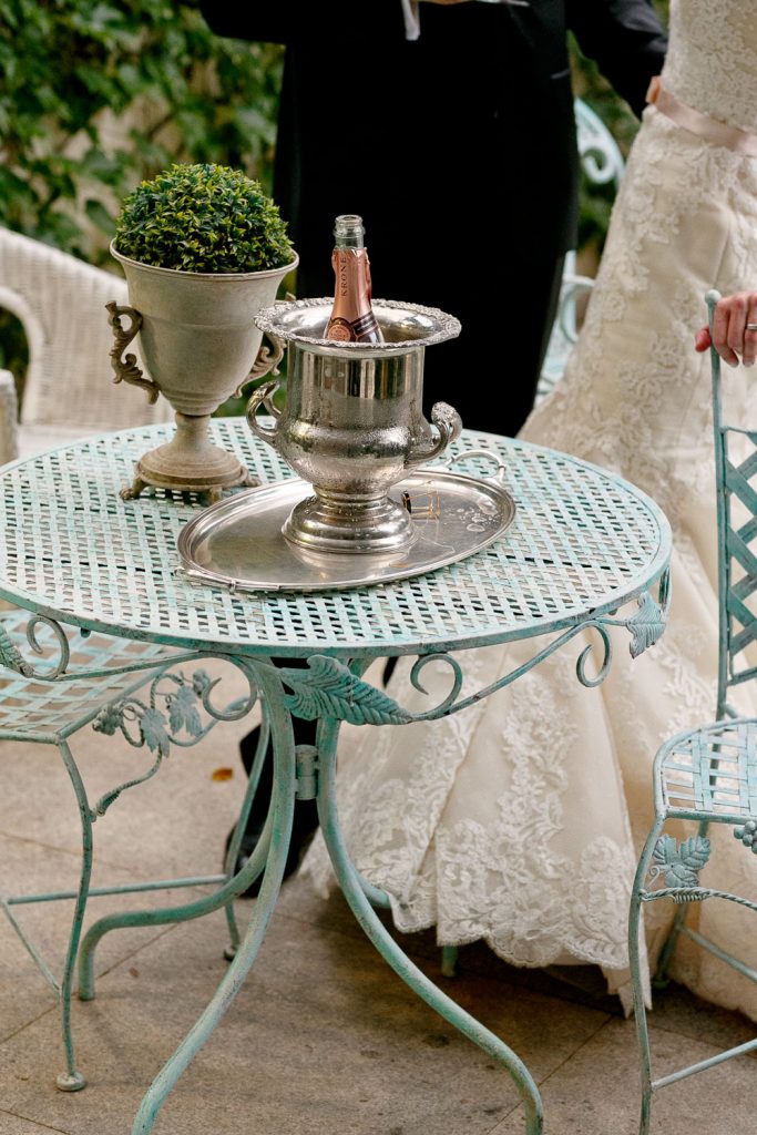 champagne bottle standing on a green garden table at Illyria House in Muckleneuk Pretoria