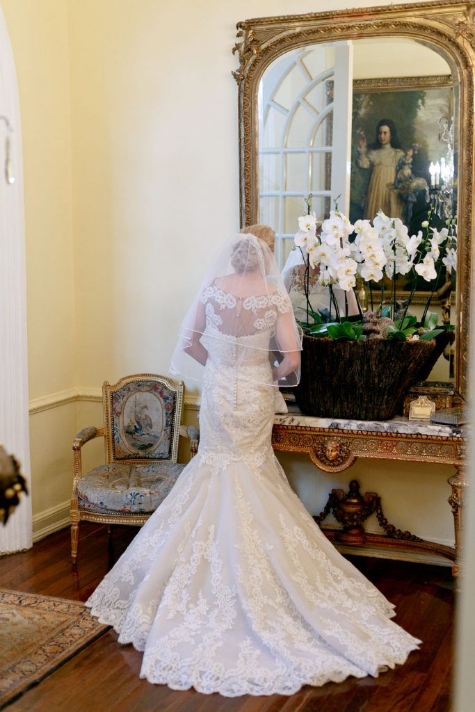 Pretoria bride standing in front of the grand golden mirror at Illyria House in Pretoria