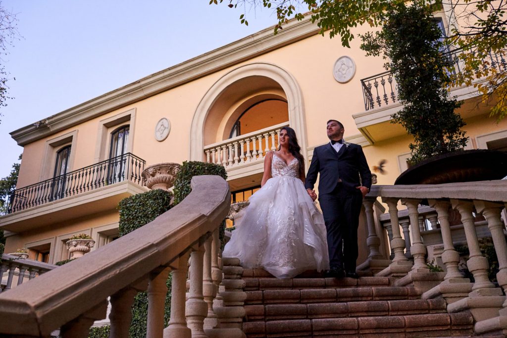 Bride and groom walking down the stairs at Le Chatelat Residence