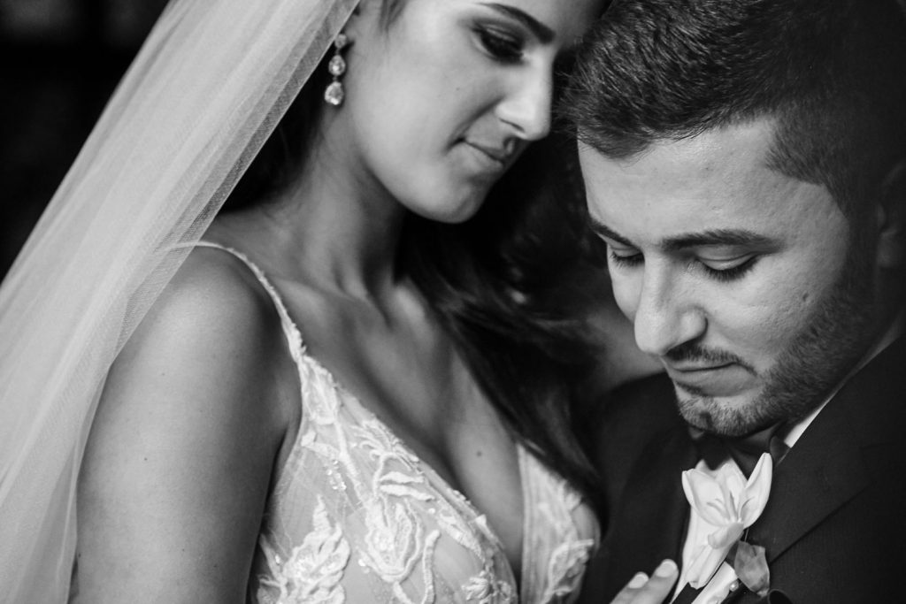 a black and white wedding image of the couple embracing at Le Chatelat Residence