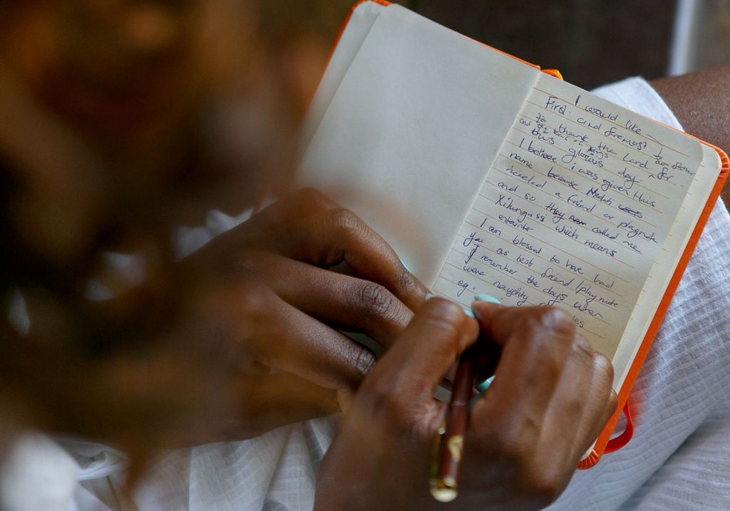 bride writing in her wedding book at red ivory lodge