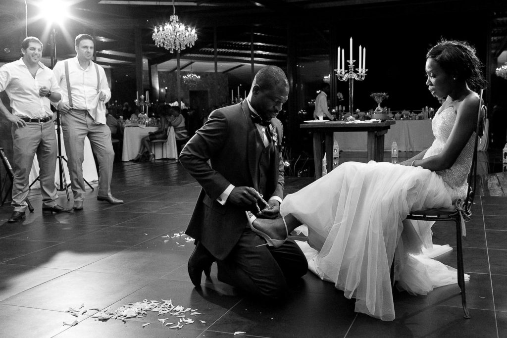 The groom looking for garter at Red Ivory Lodge