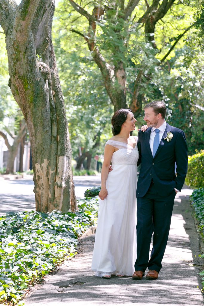 Wedding couple walking under the trees in Johannesburg