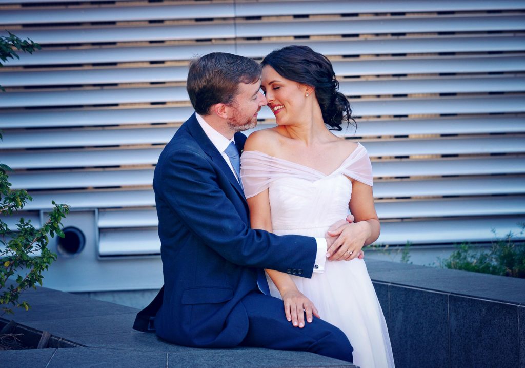 groom hugging bride outside Standard Bank in Rosebank