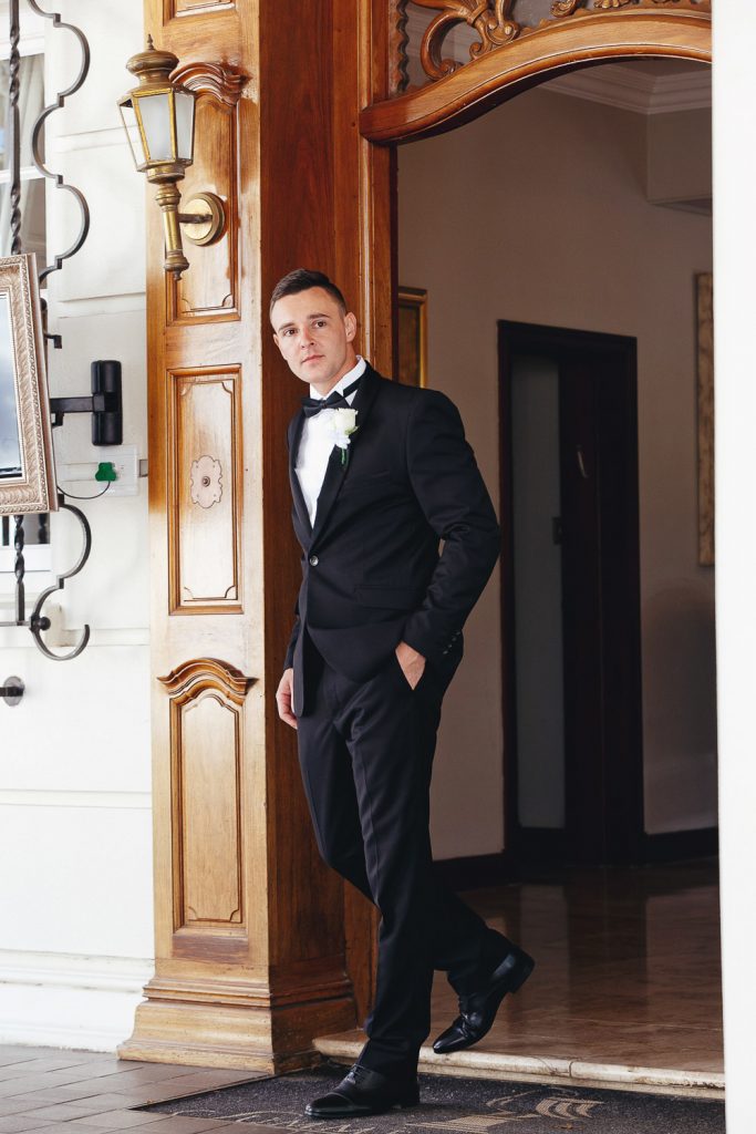 Groom walling out of the building at Summer Place Wedding Venue