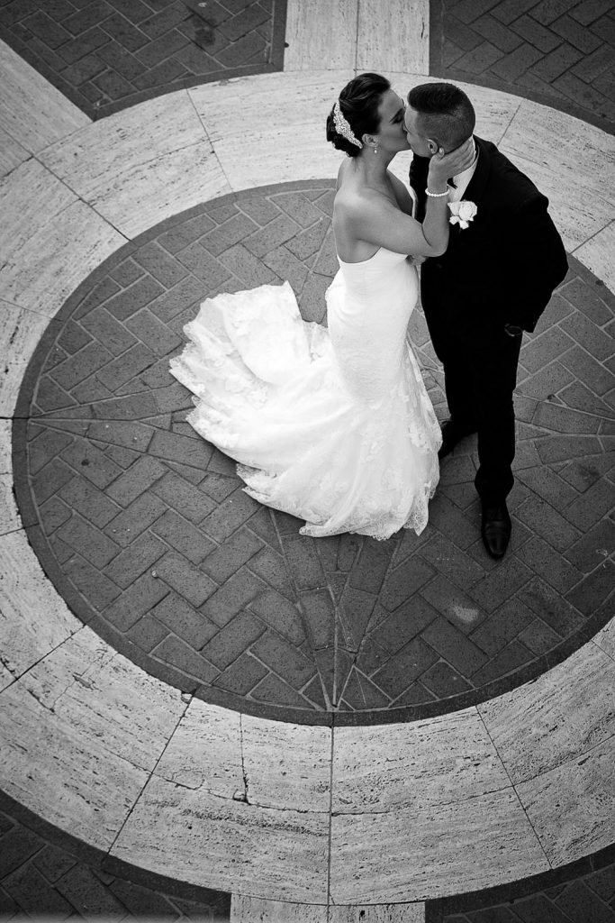 Black and white image of the couple kissing at Summer Place Sandton