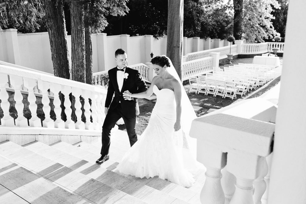 black and white image of wedding couple walking up the stairs at Summer Place Sandton