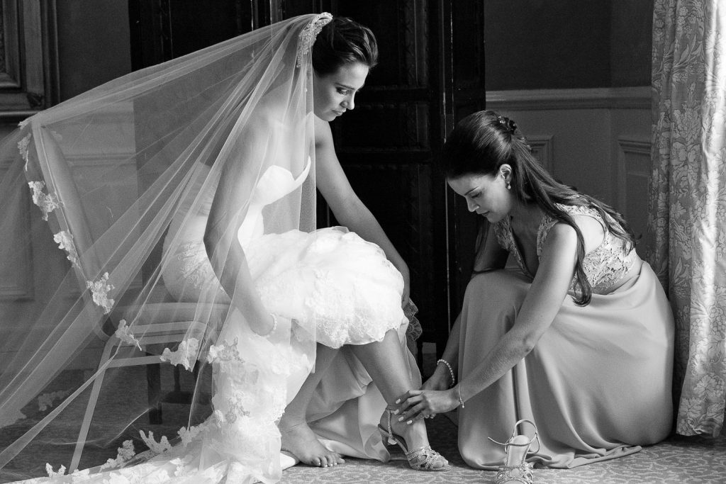 black and white image of the bride putting on wedding shoes Summer Place wedding venue