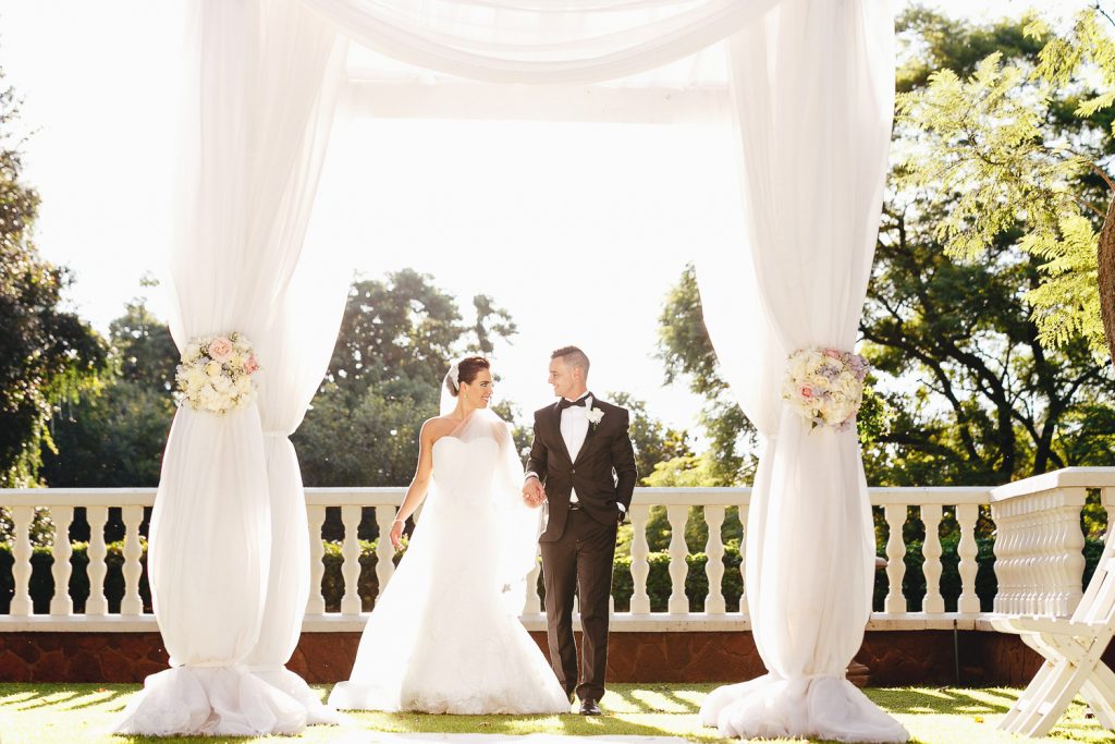 wedding couple walking in the gardens at Summer Place Sandton