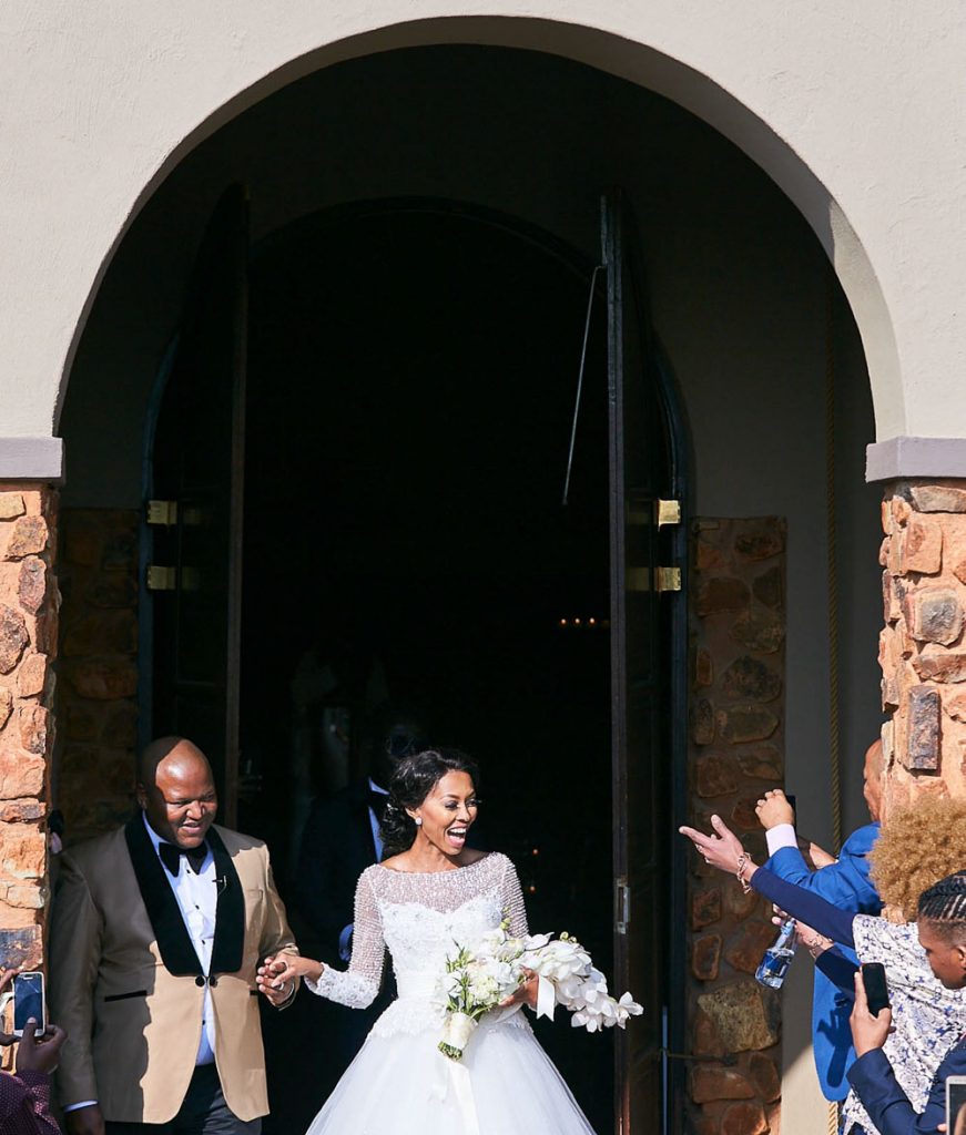 African wedding couple walking out of the church service at Thaba Eco Hotel wedding venue