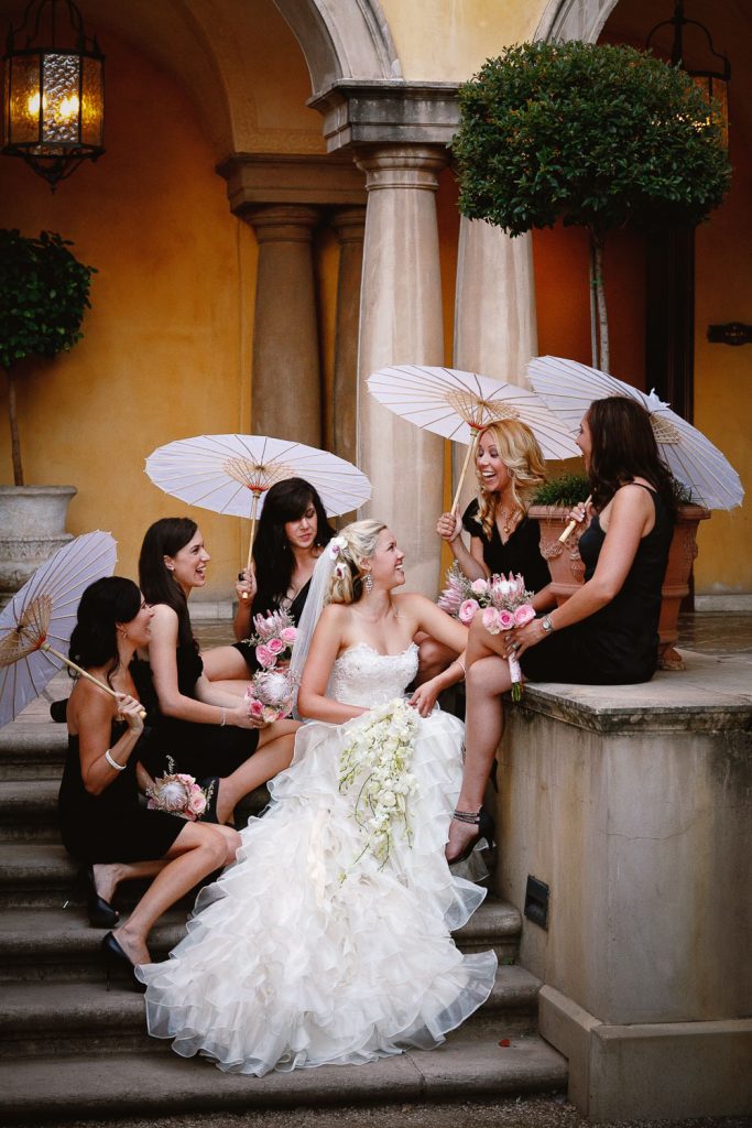 bridesmaids in black dresses sitting on the steps at Palazzo Hotel Montecasino