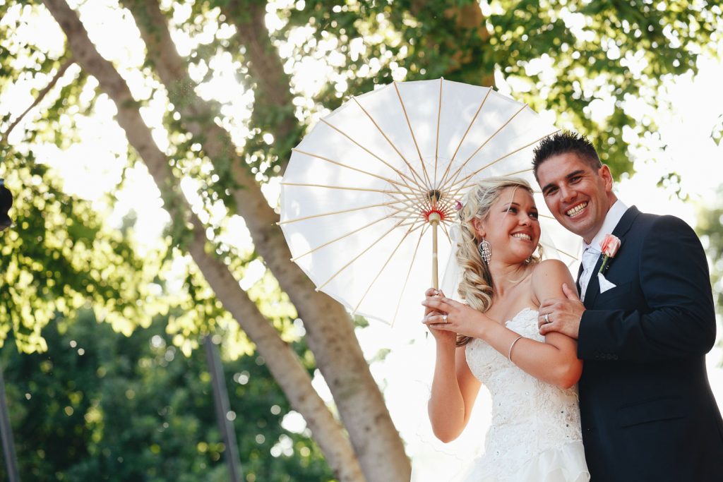 wedding couple posing under Chinese umbrella at Palazzo Hotel Montecasino