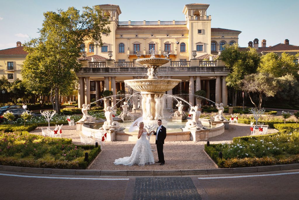 wedding couple standing in front of the fountains at Palazzo Hotel Montecasino
