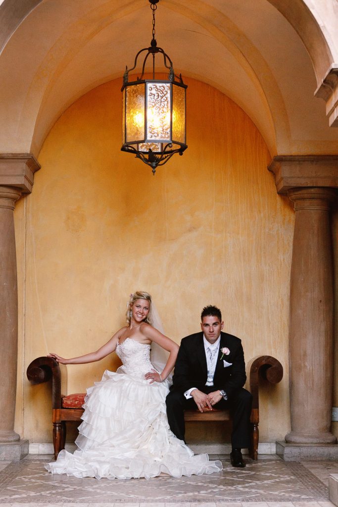 wedding couple sitting under the arches at Palazzo Hotel Montecasino