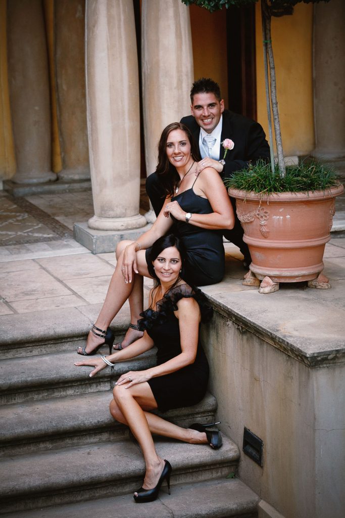 bridesmaids in black dresses sitting on the stairs at Palazzo Hotel Montecasino