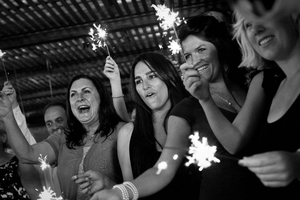 wedding guests celebrating with sparkles  at Longmeadow Farm Fourways