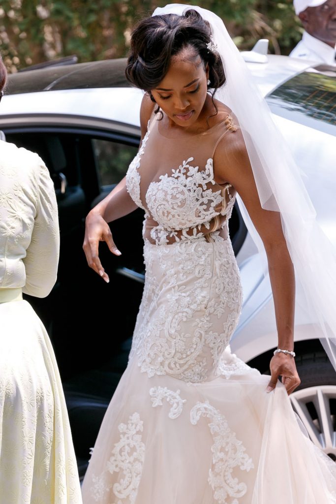 bride getting out of the wedding car at Rosebank Catholic Church