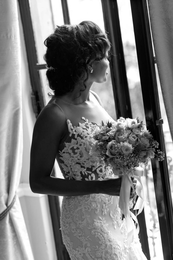 black and white image of the bride holding her wedding bouquet at Le Chatelat in Sandhurst