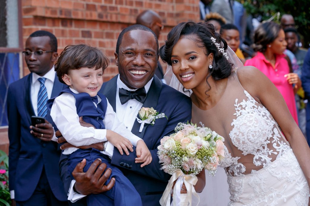 wedding couple holding the Page Boy at the Rosebank Catholic Church in Rosebank