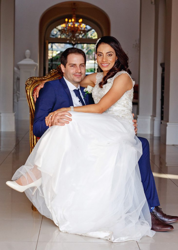bride sitting on the grooms lap at the Munro Boutique Hotel wedding venue in Parktown Johannesburg