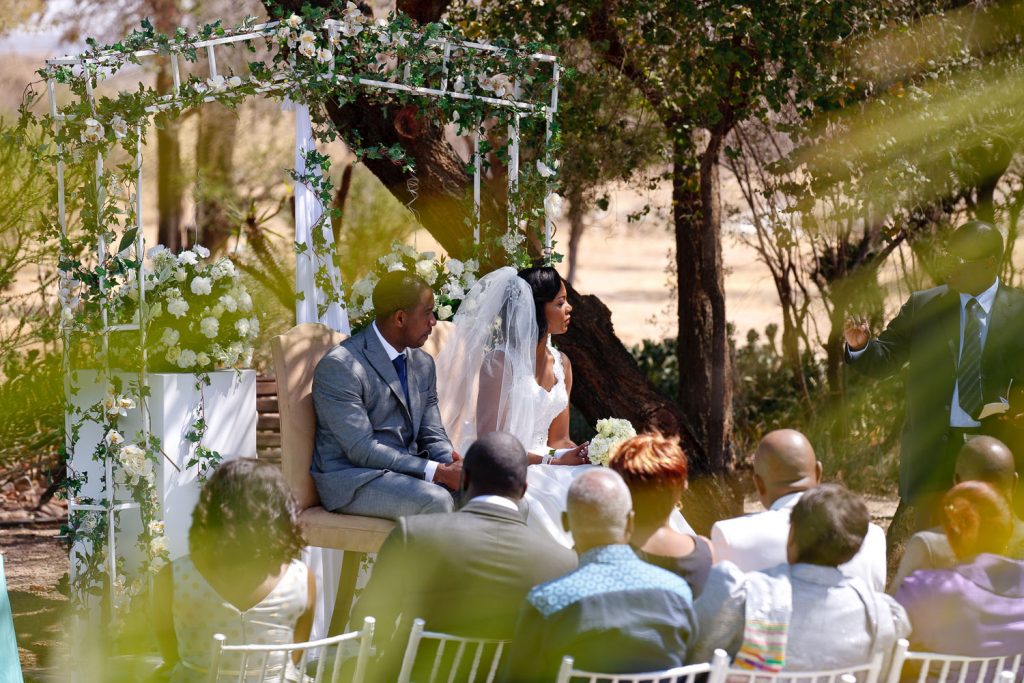 African wedding couple sitting in the African Sun
