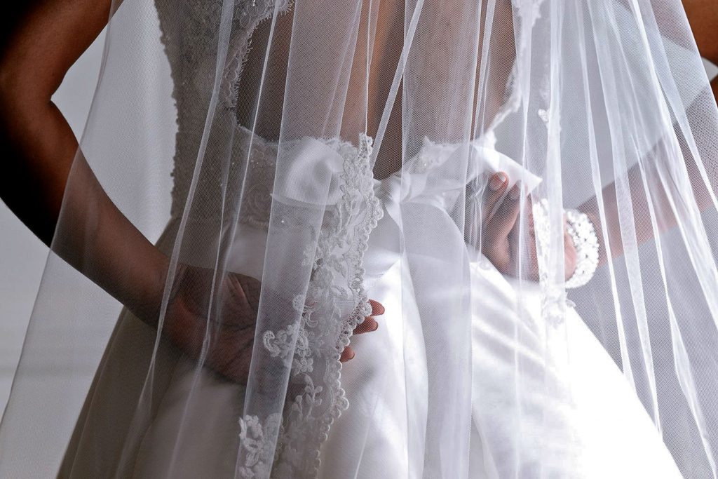 veil hanging over the brides wedding dress