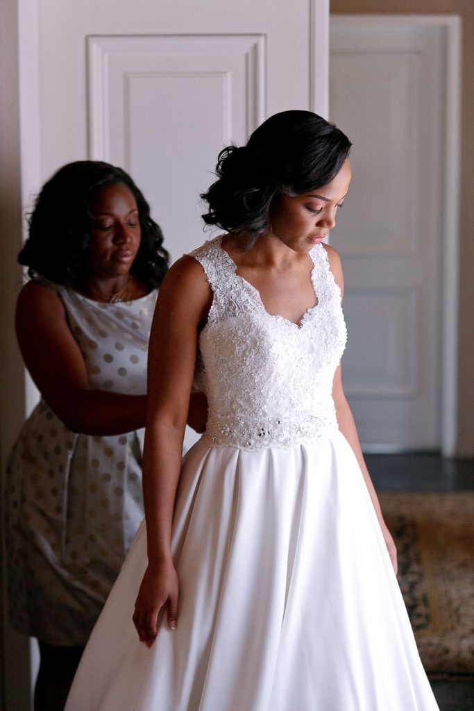 bridesmaid dressing the bride at her wedding in Botswana