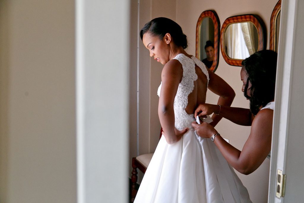 Bride getting dressed at her wedding in Gabarone