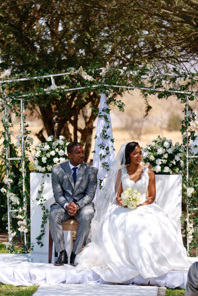 African bride and groom Botswana sitting under the trees