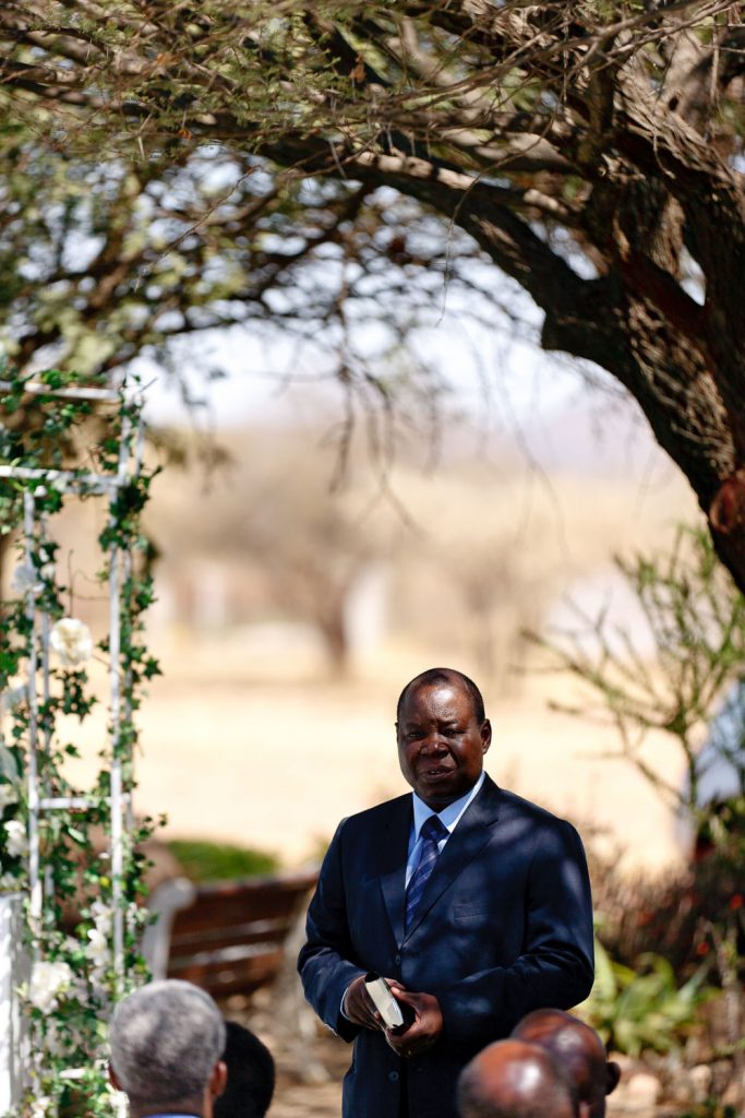 African wedding paster standing under the trees in Botswana