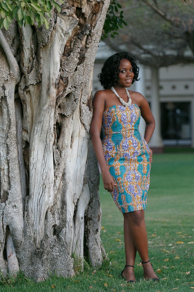 bridesmaid leaning against the Tree at the Grand Palm Hotel Botswana