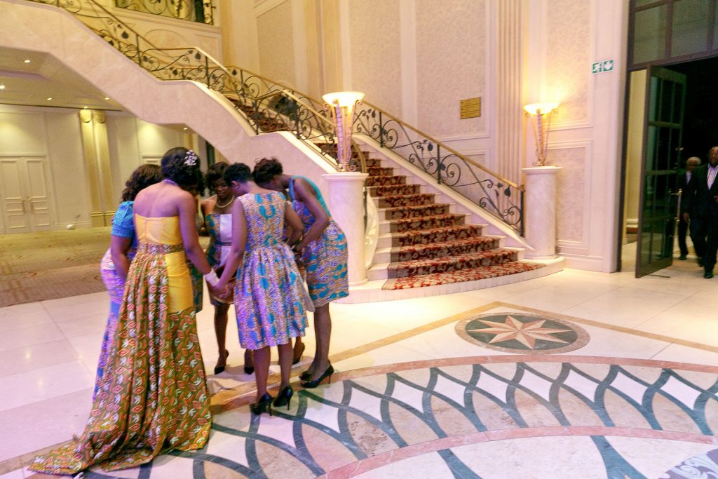 wedding guests praying at the reception hall at the Grand Palm Hotel Gabarone
