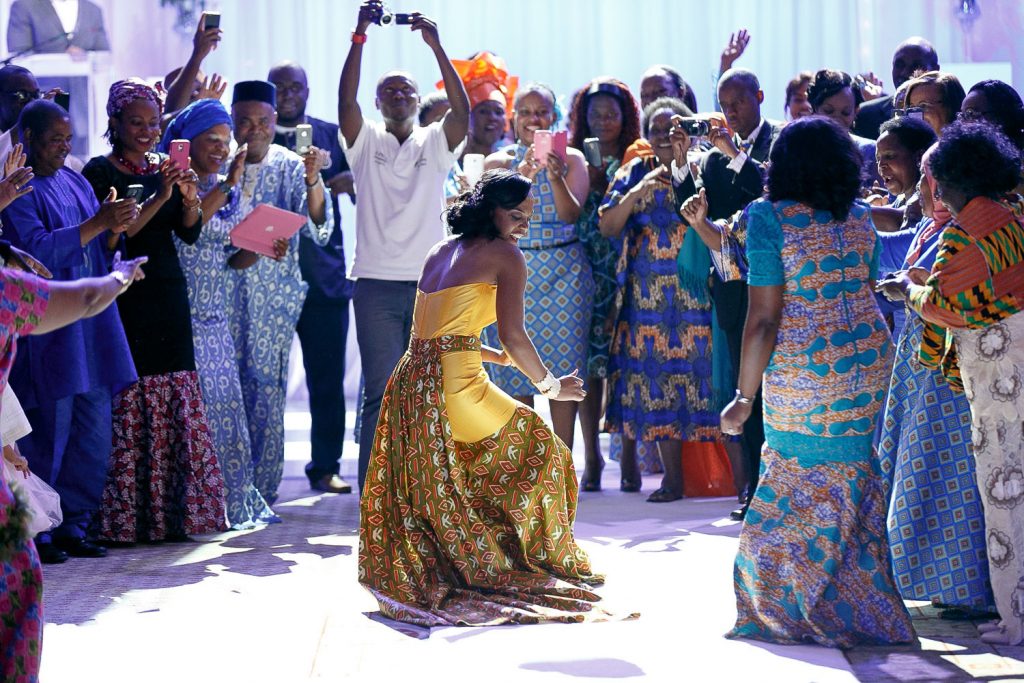 African bride in her traditional yellow wedding dress dancing the Grand Palm Hotel Botswana