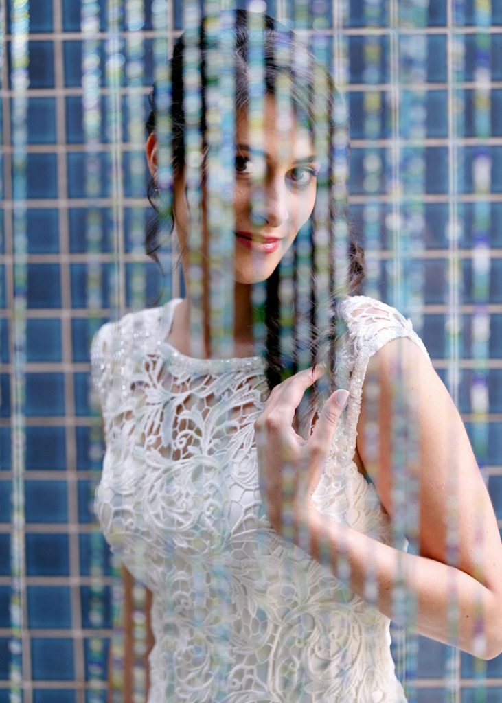 Jewish Weddings in Johannesburg bride posing behind beads