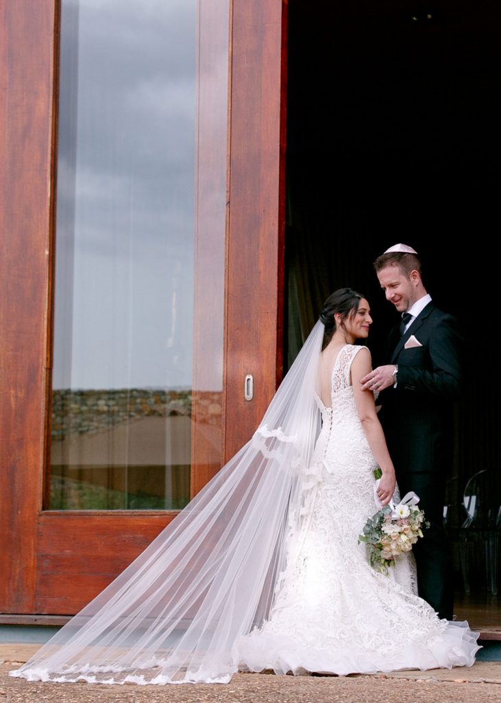 Jewish groom hugging his wife at Forum Homini