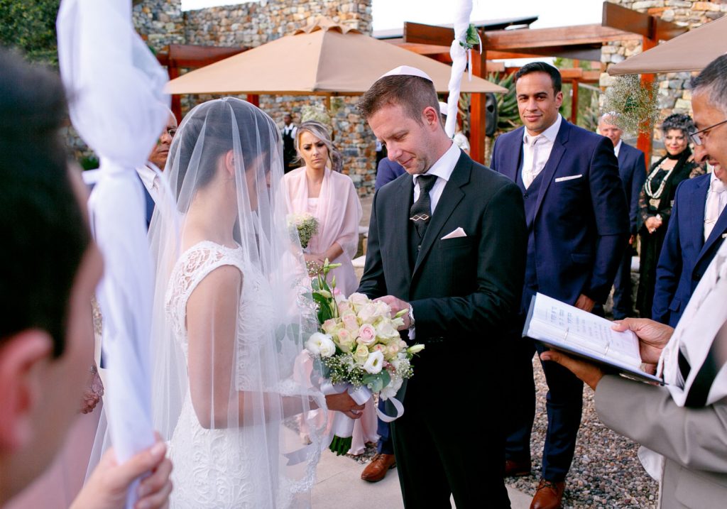 groom slipping on the ring at Johannesburg Jewish wedding