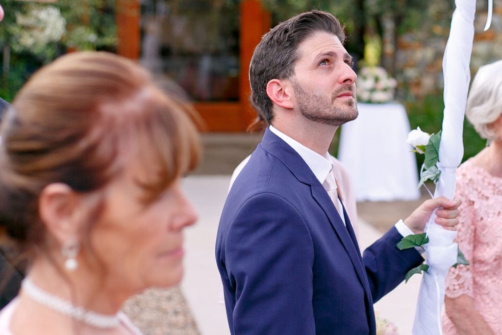 Jewish men holding the canopy poles at the Chuppah