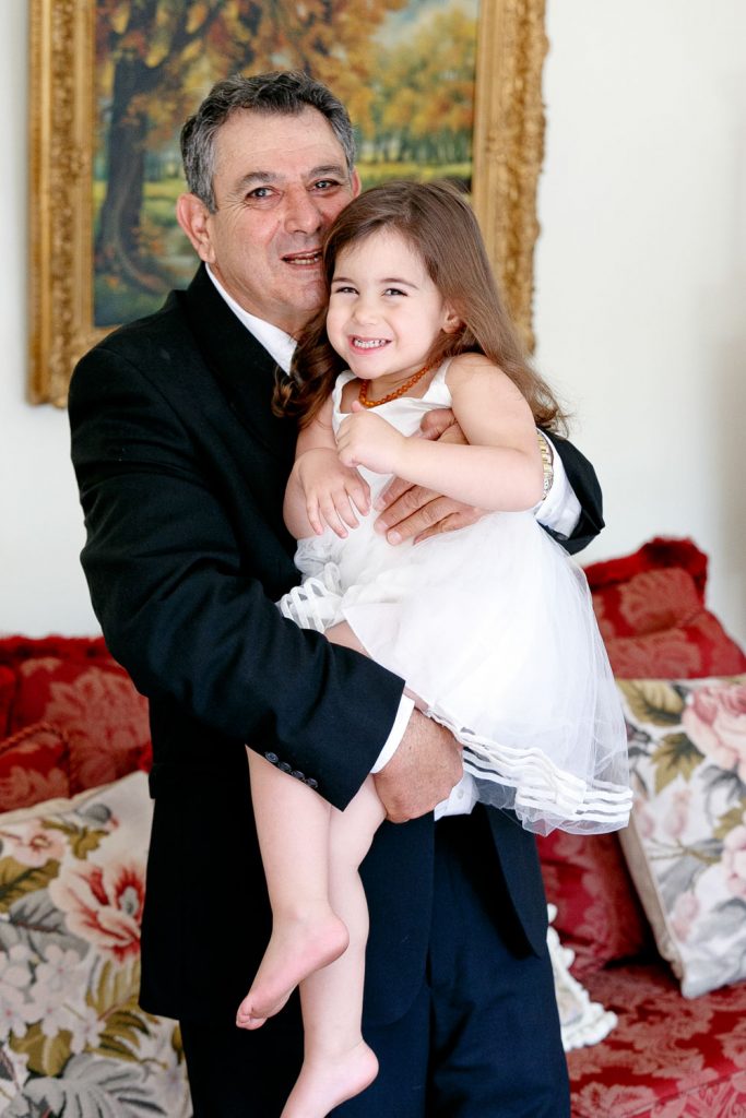 Jewish man holding his granddaughter