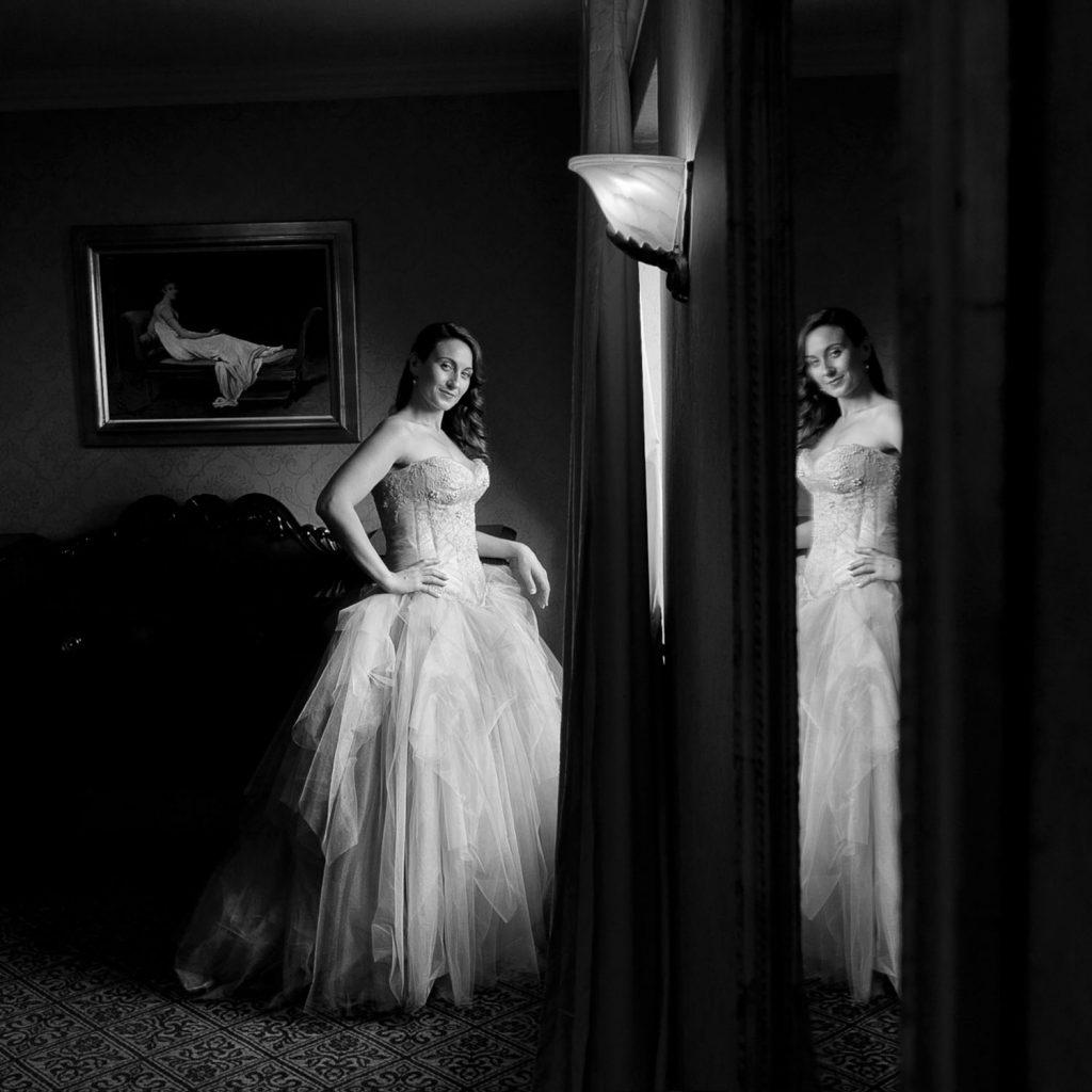 black and white photograph of a Jewish bride standing by the window