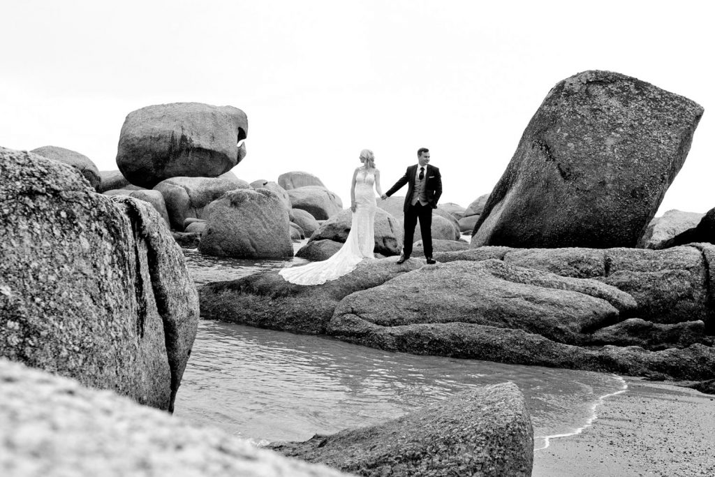 Black and white image of the wedding couple on the beach at Camps Bay